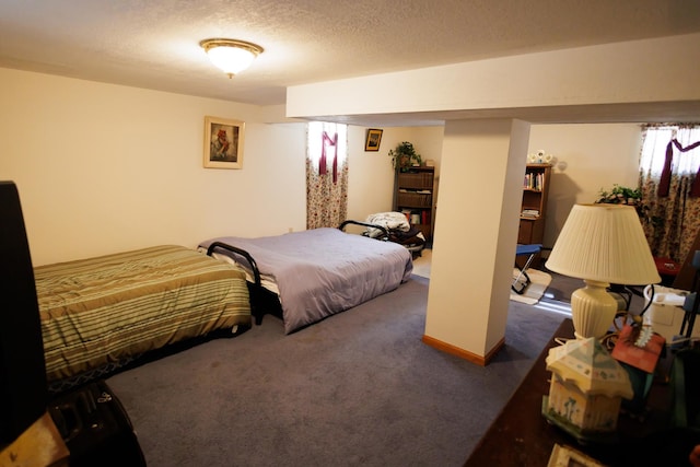 bedroom featuring dark carpet and a textured ceiling