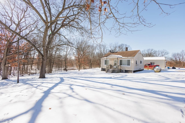 view of snow covered rear of property