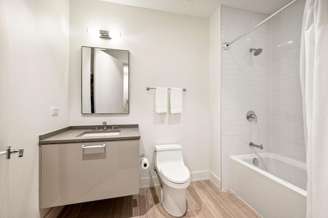 full bathroom with hardwood / wood-style floors, shower / bath combo, toilet, and vanity