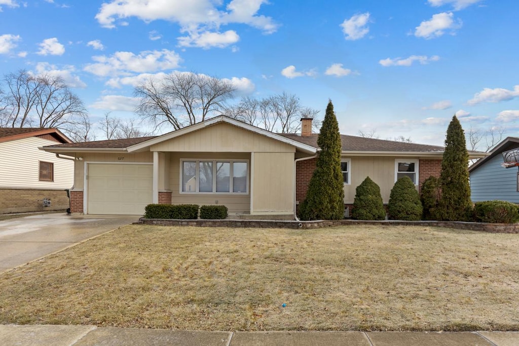 ranch-style home with a front yard and a garage