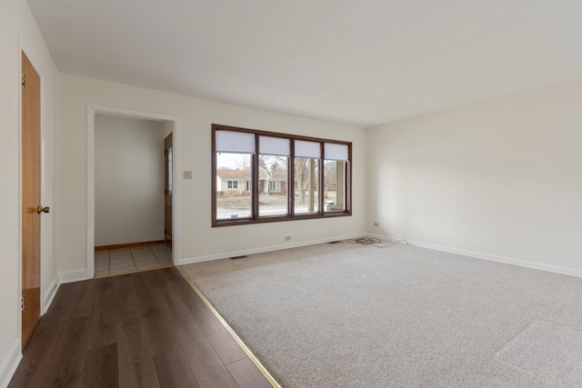 spare room featuring dark wood-type flooring