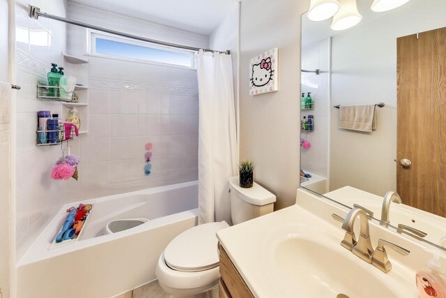 full bathroom with vanity, toilet, and shower / bathtub combination with curtain