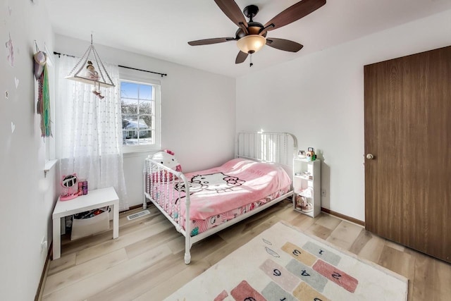 bedroom with hardwood / wood-style floors and ceiling fan