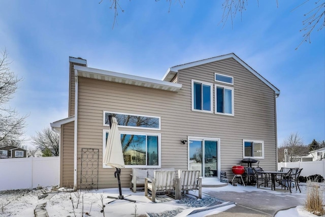 snow covered property featuring an outdoor living space and a patio area