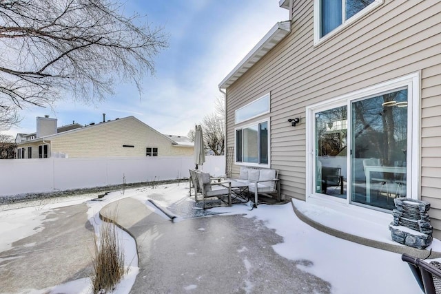 snow covered patio featuring an outdoor living space