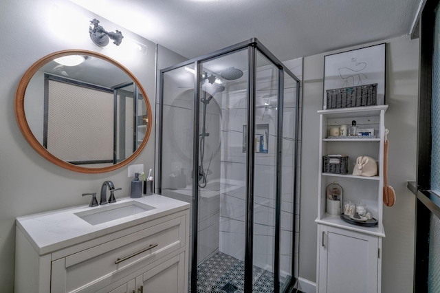 bathroom featuring vanity and a shower with door