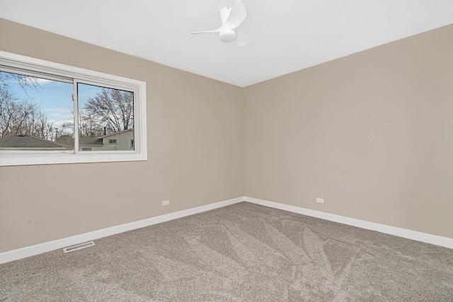 carpeted spare room featuring ceiling fan