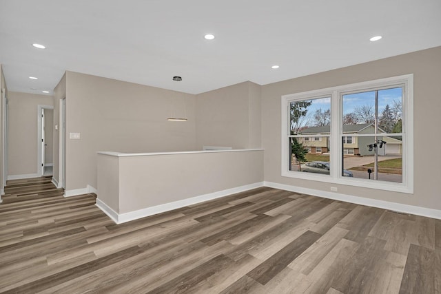 empty room with hardwood / wood-style floors