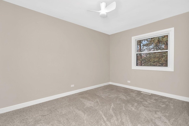 unfurnished room featuring ceiling fan and carpet floors