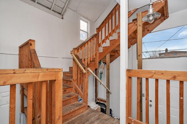 staircase with hardwood / wood-style floors