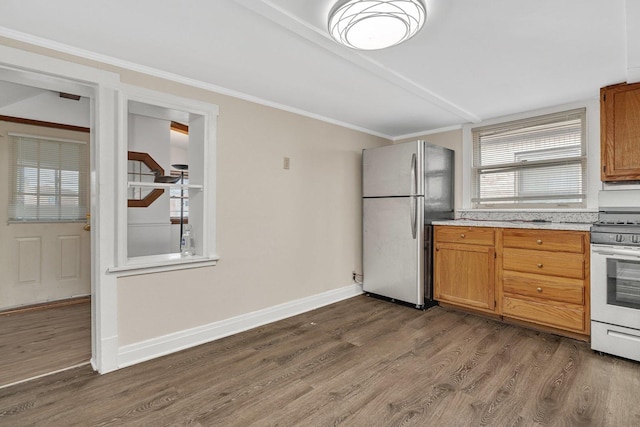 kitchen with white range oven, stainless steel refrigerator, dark hardwood / wood-style floors, and crown molding