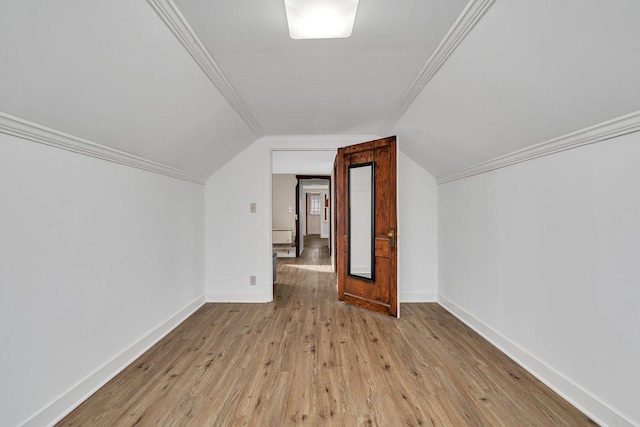 additional living space with lofted ceiling and light hardwood / wood-style flooring