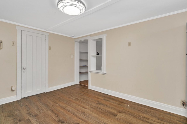 unfurnished room with crown molding and dark hardwood / wood-style flooring