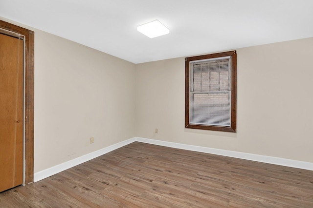 unfurnished room with hardwood / wood-style flooring