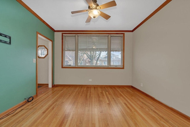 empty room featuring ceiling fan, light hardwood / wood-style floors, and ornamental molding