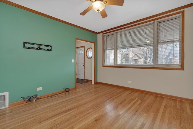 spare room with light hardwood / wood-style flooring, ceiling fan, and ornamental molding