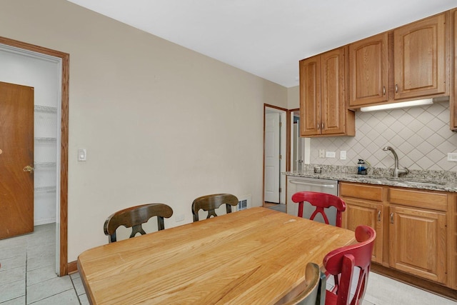 tiled dining space featuring sink