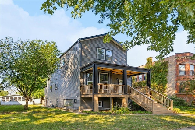 back of house with a lawn