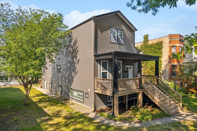 rear view of property with a yard