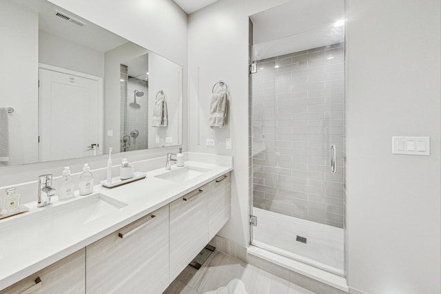 bathroom with tile patterned floors, vanity, and a shower with shower door