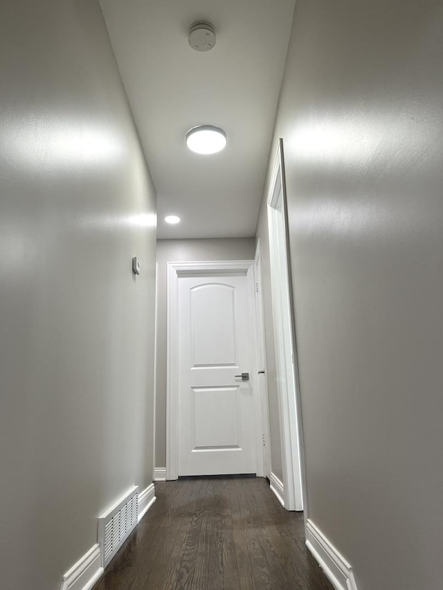 corridor featuring dark wood-type flooring