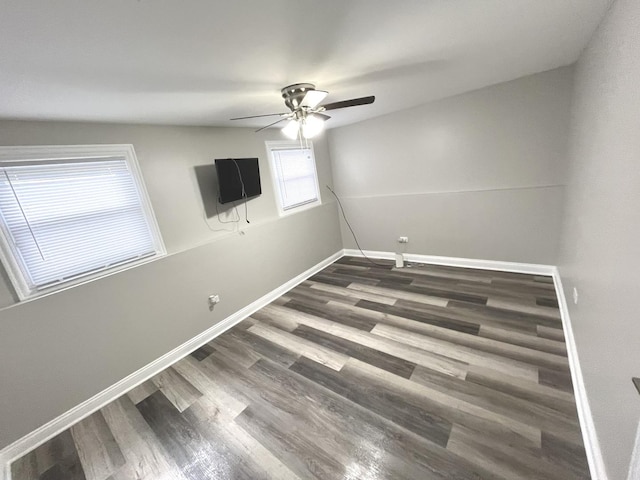 unfurnished room with ceiling fan and dark hardwood / wood-style flooring