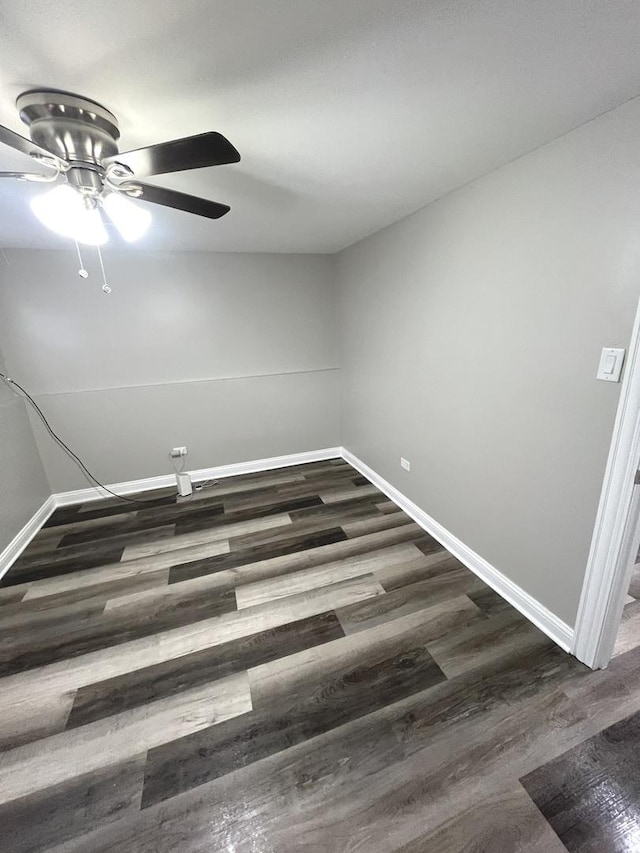 unfurnished room with ceiling fan and dark wood-type flooring