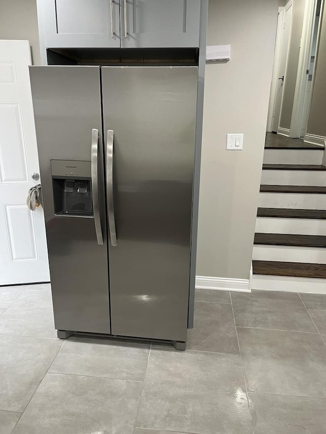 kitchen featuring stainless steel fridge and gray cabinets