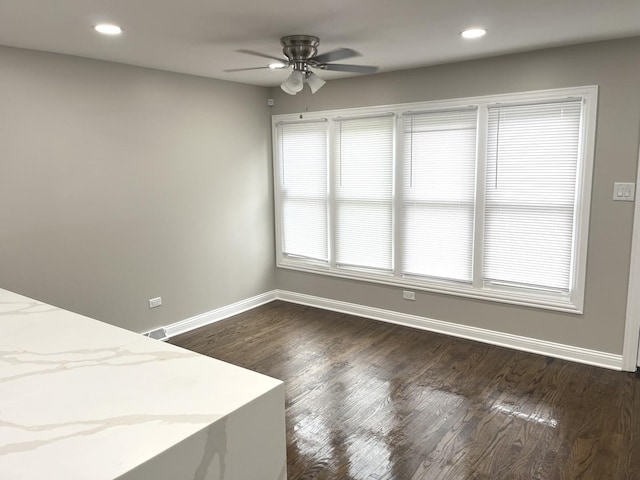 unfurnished bedroom featuring ceiling fan and dark hardwood / wood-style floors