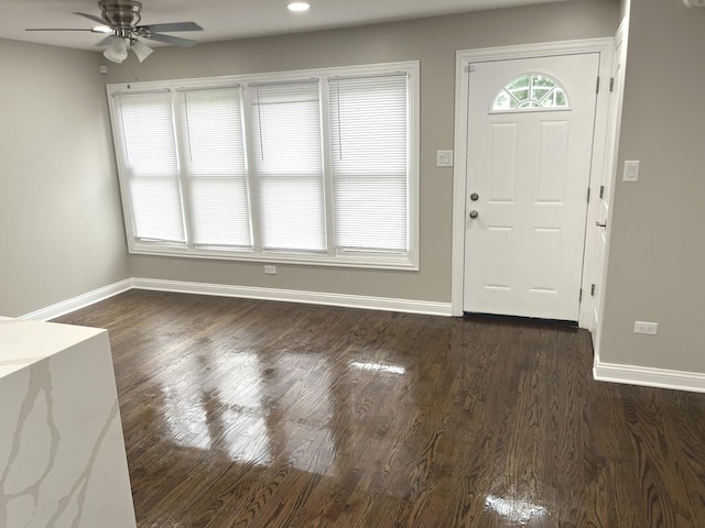 entryway with ceiling fan and dark wood-type flooring