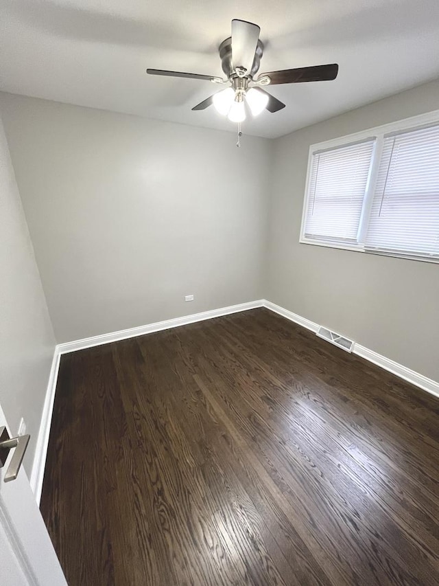 unfurnished room with ceiling fan and dark hardwood / wood-style flooring