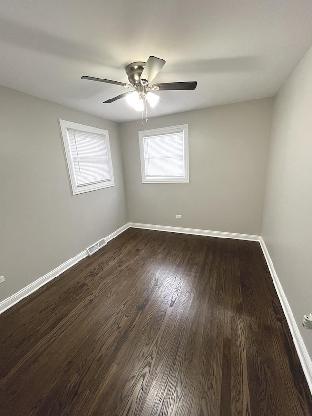 spare room with hardwood / wood-style floors and ceiling fan