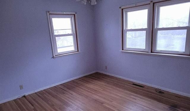 empty room with hardwood / wood-style flooring