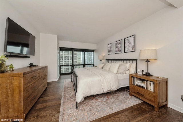 bedroom with dark wood-type flooring