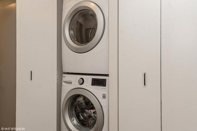 clothes washing area with stacked washer / drying machine