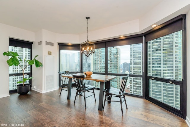 dining room featuring hardwood / wood-style flooring and a notable chandelier