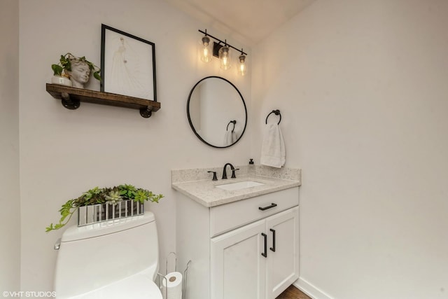 bathroom featuring vanity and toilet