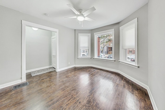 empty room featuring ceiling fan and dark hardwood / wood-style flooring