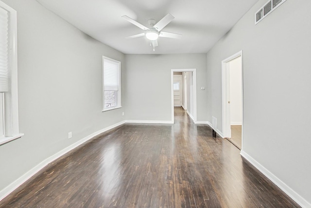 unfurnished room with ceiling fan and dark hardwood / wood-style floors