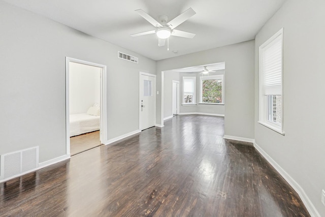 spare room featuring ceiling fan and dark hardwood / wood-style flooring