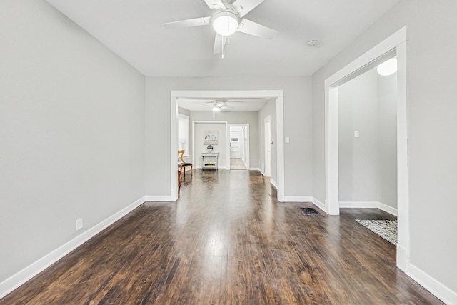 interior space with dark wood-type flooring and ceiling fan