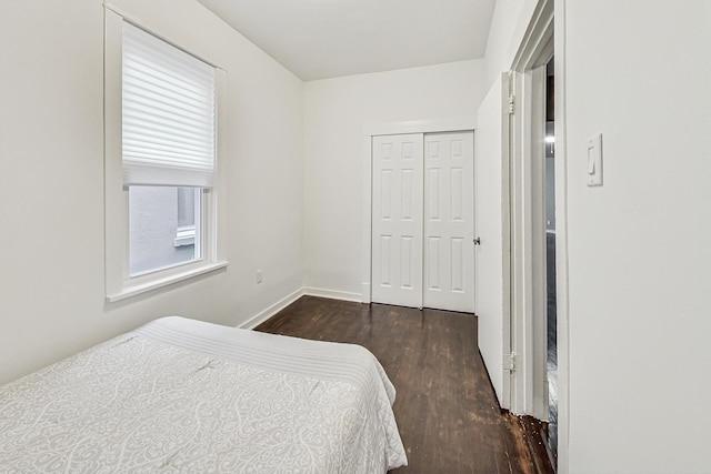 bedroom featuring dark hardwood / wood-style flooring and a closet