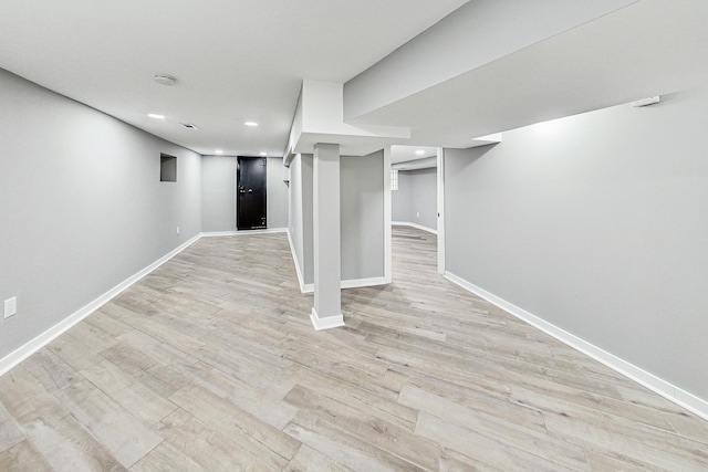 basement with light hardwood / wood-style floors