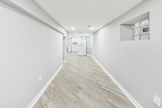 hall with light wood-type flooring