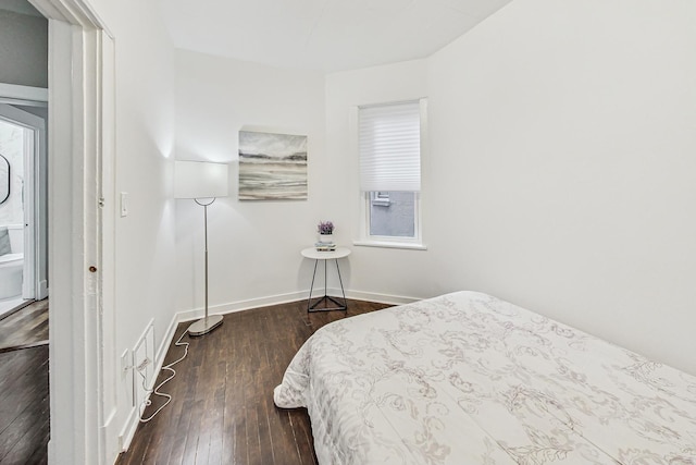 bedroom with dark wood-type flooring