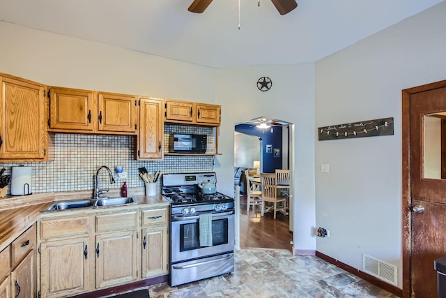 kitchen featuring backsplash, sink, and stainless steel range with gas stovetop