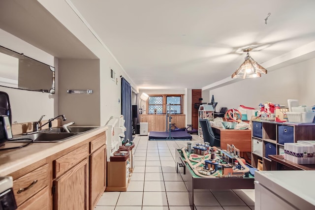 kitchen featuring light tile patterned floors, range, and sink