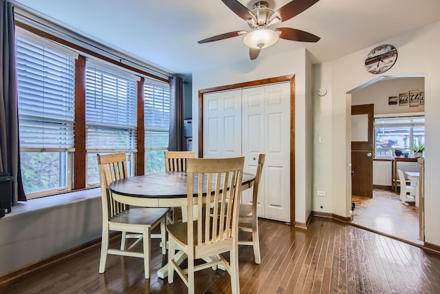 dining area featuring ceiling fan and dark wood-type flooring