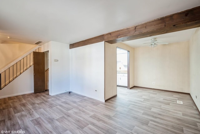 spare room featuring ceiling fan, beam ceiling, and light wood-type flooring