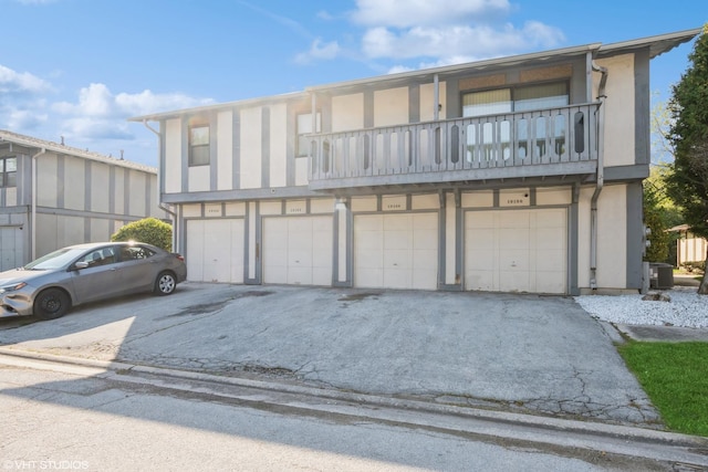 view of front of house featuring a garage and a balcony